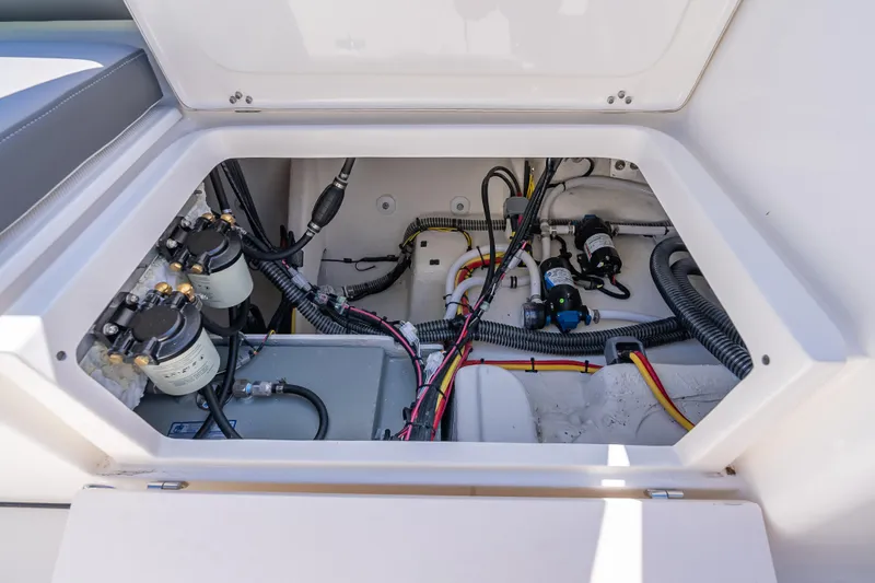 Slide: The Image of 2026 Sea Born LX27 Center Console boat wiring and components inside storage compartment. - 34