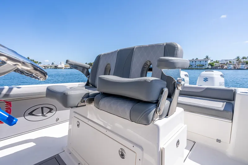 Slide: The Image of 2026 Sea Born LX27 Center Console boat with luxurious seating, docked by the water. - 35