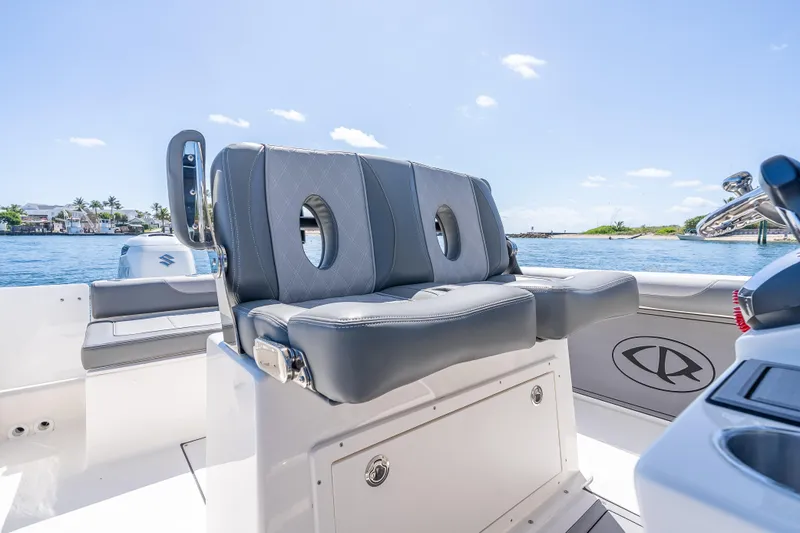 Slide: The Image of 2026 Sea Born LX27 Center Console boat interior with gray seating and ocean view. - 39