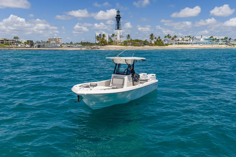 Slide: The Image of 2026 Sea Born LX27 Center Console boat on ocean near lighthouse and coastline. - 4
