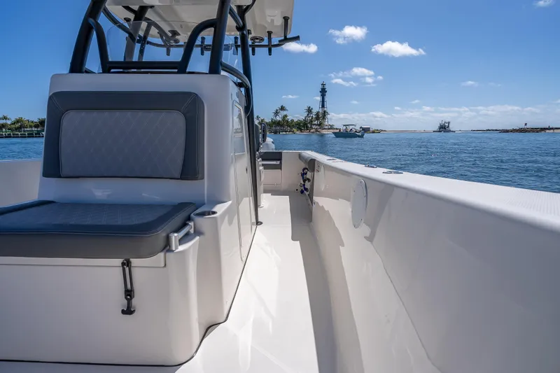 Slide: The Image of 2026 Sea Born LX27 Center Console boat on calm waters near a lighthouse. - 42