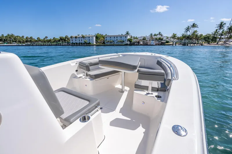 Slide: The Image of 2026 Sea Born LX27 Center Console boat on clear blue water, featuring spacious seating. - 46