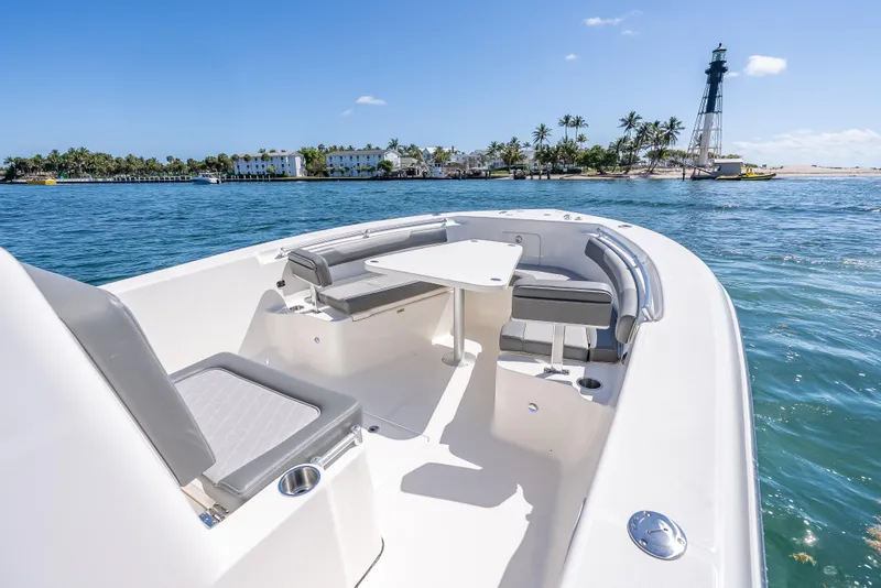Slide: The Image of 2026 Sea Born LX27 Center Console boat on water near lighthouse and palm trees. - 47