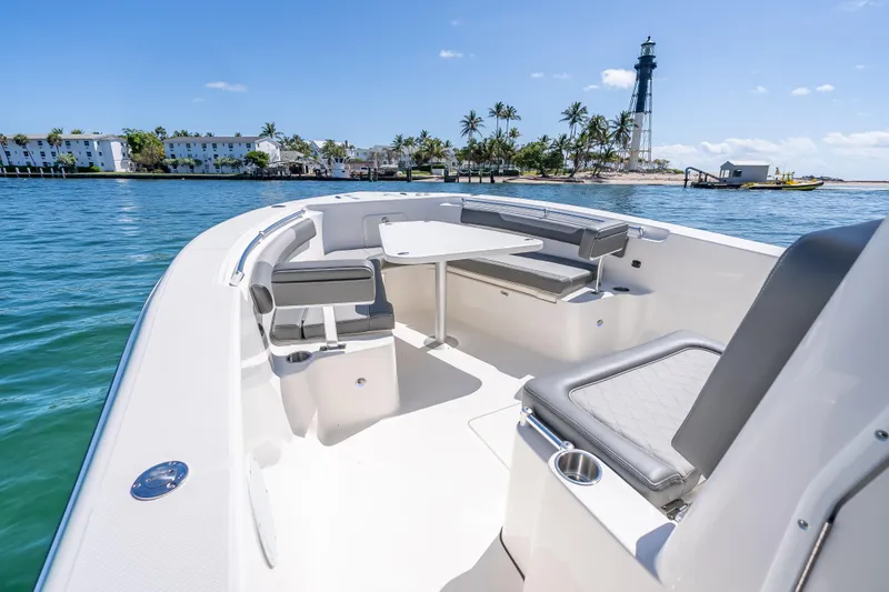 Slide: The Image of 2026 Sea Born LX27 Center Console boat with seating, table, and ocean view. - 48