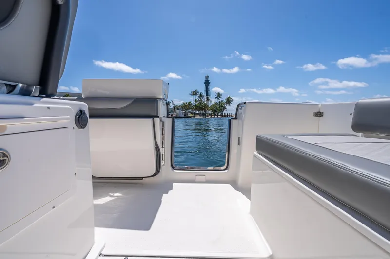 Slide: The Image of 2026 Sea Born LX27 Center Console boat interior with ocean view and lighthouse. - 55