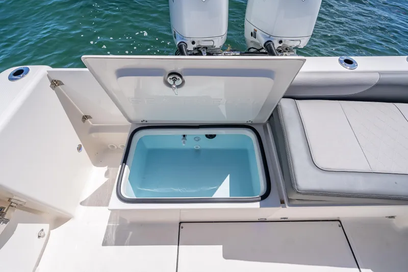 Slide: The Image of 2026 Sea Born LX27 Center Console boat with open storage compartment, near twin engines. - 56