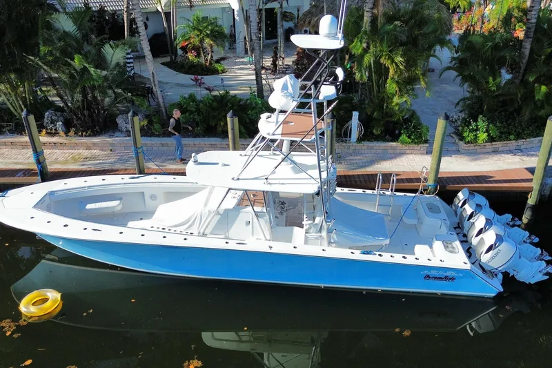 The Image of 2014 SeaHunter 45 Tournament boat docked, featuring sleek design and multiple outboard engines. - 1