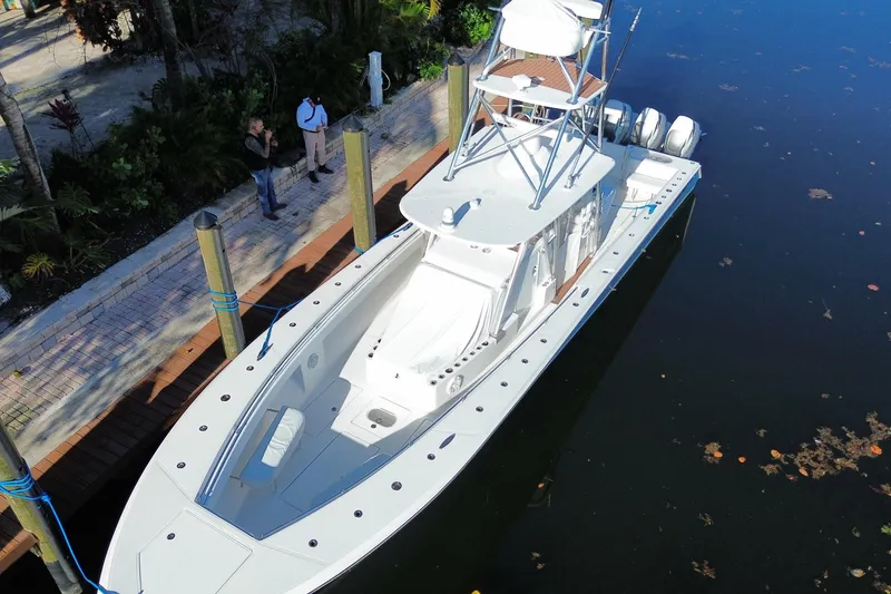 Slide: The Image of 2014 SeaHunter 45 Tournament boat docked, aerial view, with two people nearby. - 10