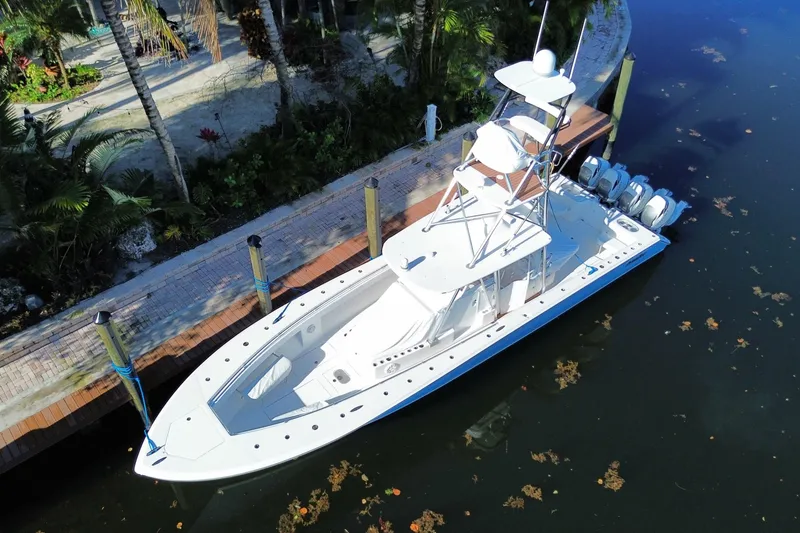 Slide: The Image of 2014 SeaHunter 45 Tournament boat docked by tropical foliage. - 11