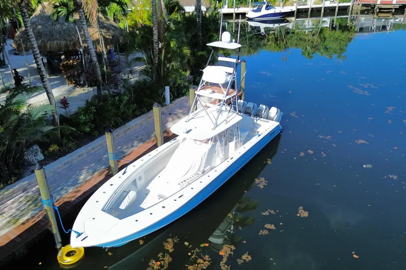 Slide: The Image of 2014 SeaHunter 45 Tournament boat docked in a serene, tropical setting. - 12