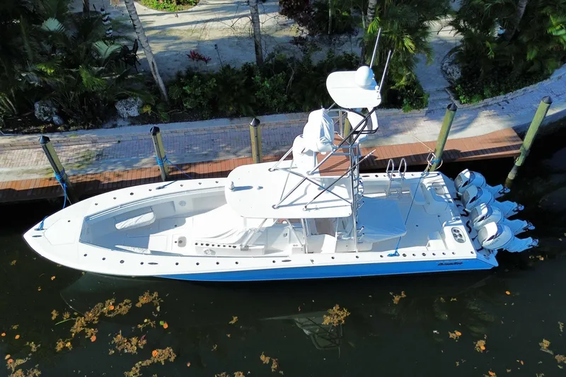 Slide: The Image of 2014 SeaHunter 45 Tournament boat docked, aerial view, surrounded by lush greenery. - 13