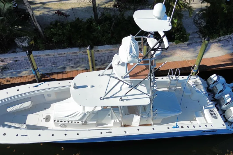 Slide: The Image of 2014 SeaHunter 45 Tournament boat docked, aerial view, showcasing spacious deck and multiple engines. - 17