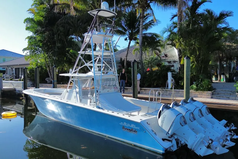 Slide: The Image of 2014 SeaHunter 45 Tournament boat docked, surrounded by tropical greenery. - 25