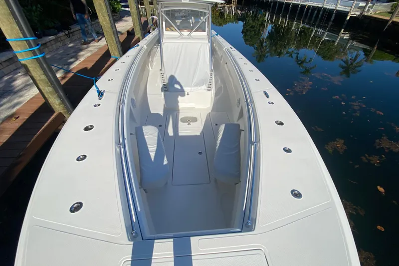 Slide: The Image of 2014 SeaHunter 45 Tournament boat docked, showcasing spacious deck and seating area. - 29