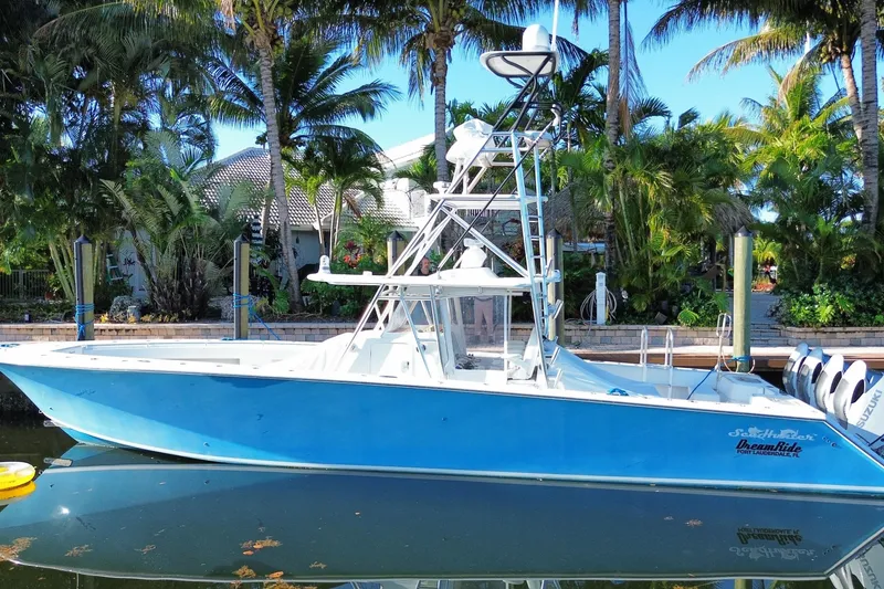 Slide: The Image of 2014 SeaHunter 45 Tournament boat docked by tropical palm trees. - 3