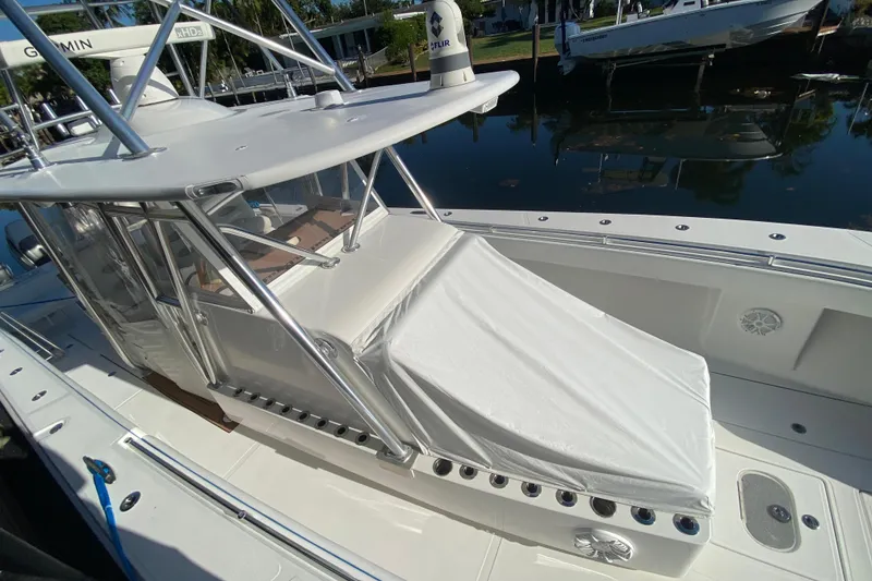 Slide: The Image of 2014 SeaHunter 45 Tournament boat with covered seating, docked by calm waters. - 35