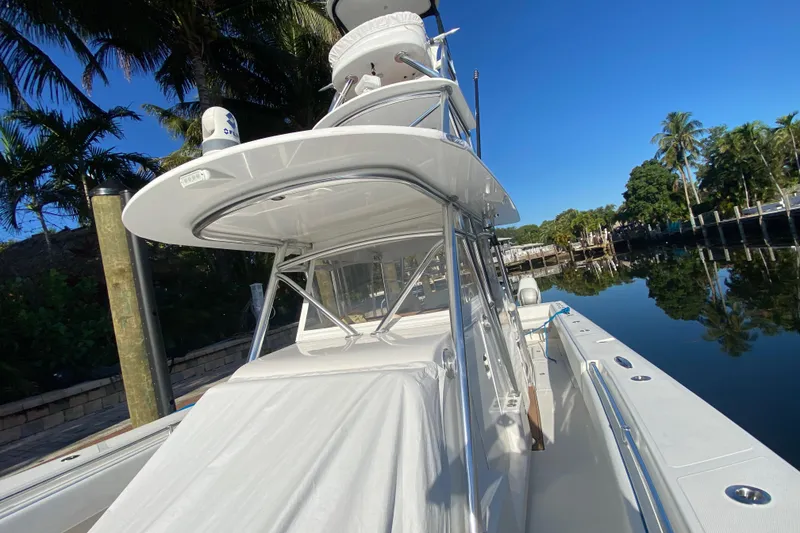 Slide: The Image of 2014 SeaHunter 45 Tournament boat docked by palm trees under clear blue sky. - 38