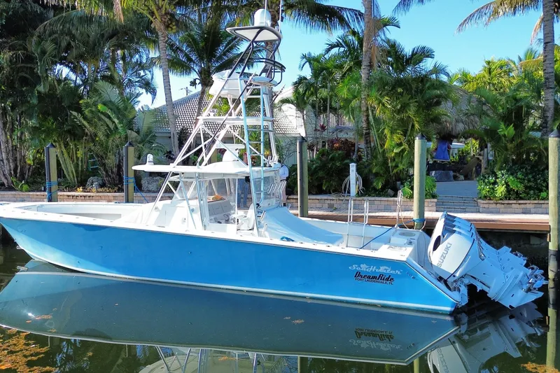 Slide: The Image of 2014 SeaHunter 45 Tournament boat docked near tropical palm trees. - 4