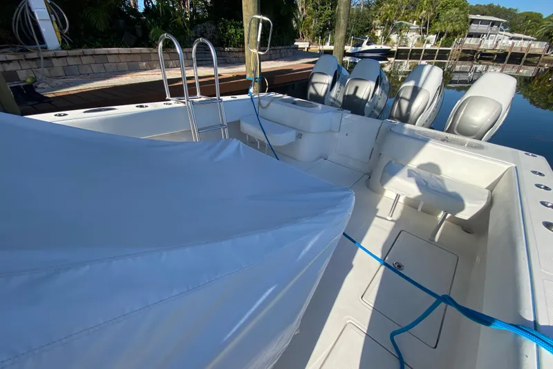 Slide: The Image of 2014 SeaHunter 45 Tournament boat interior with covered seating and multiple outboard engines. - 41