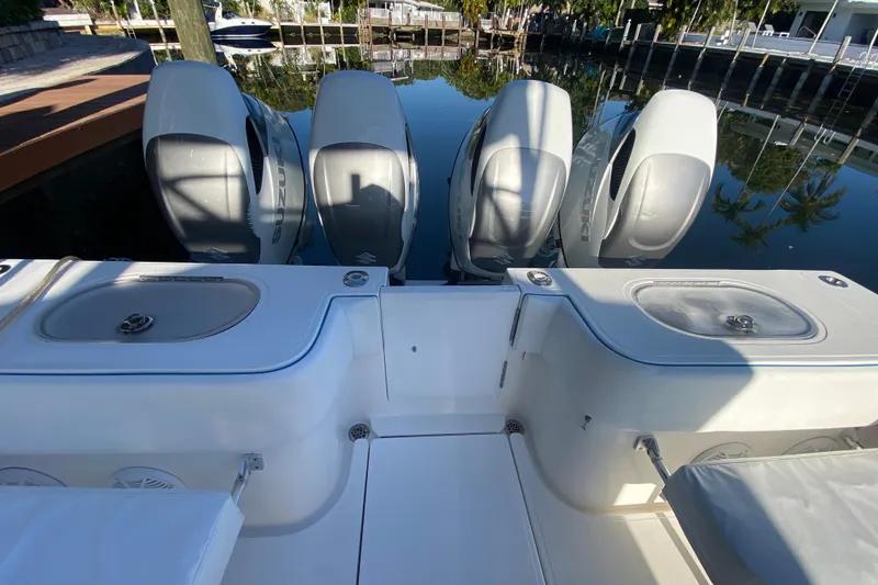 Slide: The Image of 2014 SeaHunter 45 Tournament boat with four powerful outboard engines docked by the water. - 43