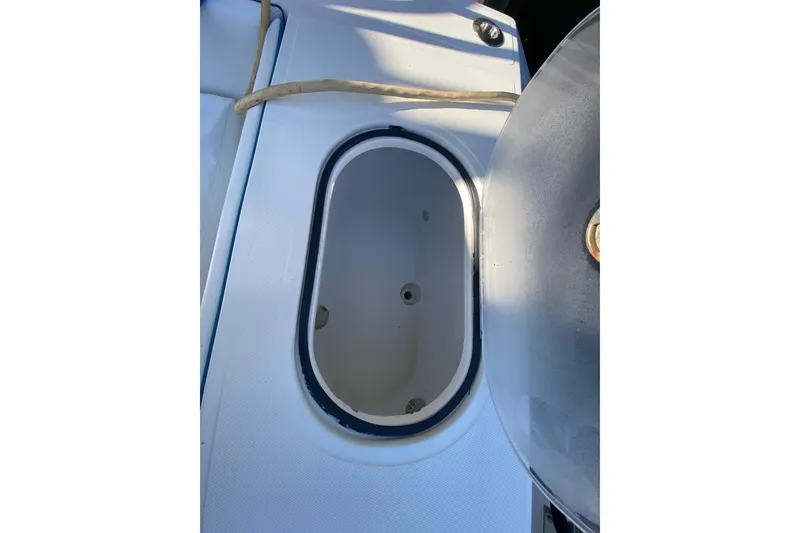 Slide: The Image of Livewell on 2014 SeaHunter 45 Tournament boat, open lid, white interior. - 45