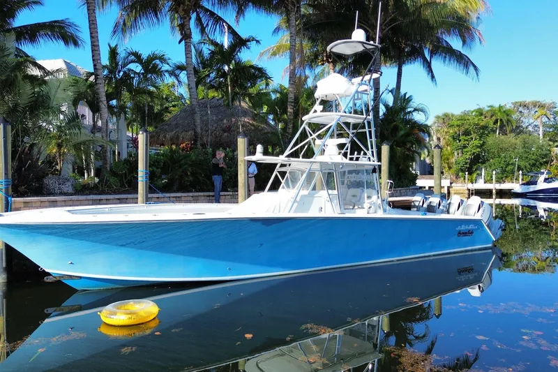 Slide: The Image of 2014 SeaHunter 45 Tournament boat docked, surrounded by tropical palm trees. - 7
