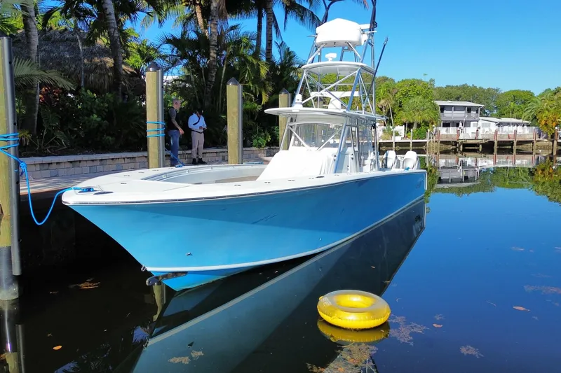 Slide: The Image of 2014 SeaHunter 45 Tournament boat docked in a serene, tropical setting. - 8
