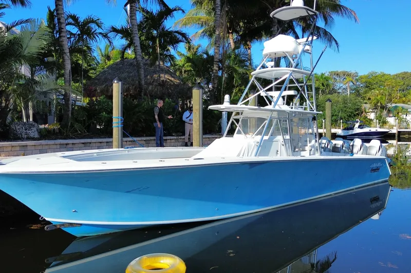Slide: The Image of 2014 SeaHunter 45 Tournament boat docked, surrounded by tropical palm trees. - 9
