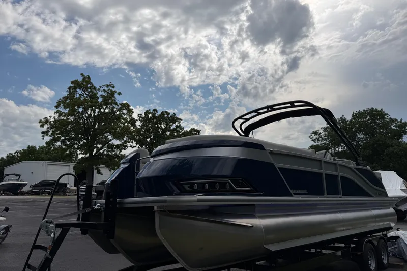 Slide: The Image of 2026 Harris Grand Mariner 250 CWDH pontoon boat under a cloudy sky. - 4