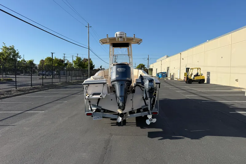 Slide: The Image of 2007 Grady-White Escape 209 boat with dual outboard motors in a parking lot. - 10