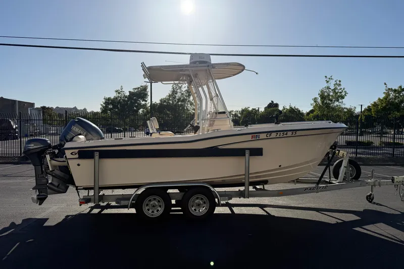 Slide: The Image of 2007 Grady-White Escape 209 boat on trailer, parked outdoors under clear sky. - 13