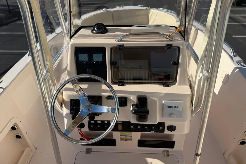 Slide: The Image of 2007 Grady-White Escape 209 boat dashboard with steering wheel and navigation controls. - 14