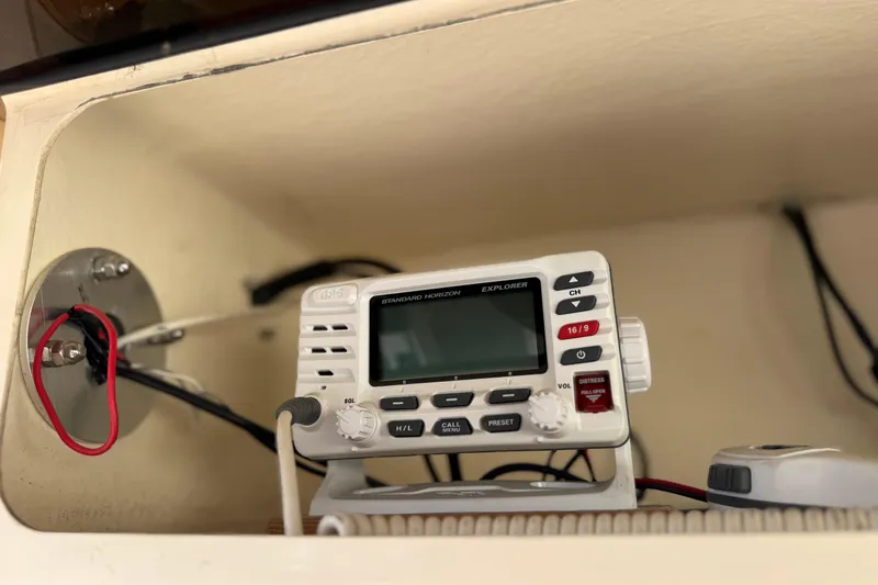 Slide: The Image of VHF radio installed on a 2007 Grady-White Escape 209 boat dashboard. - 16