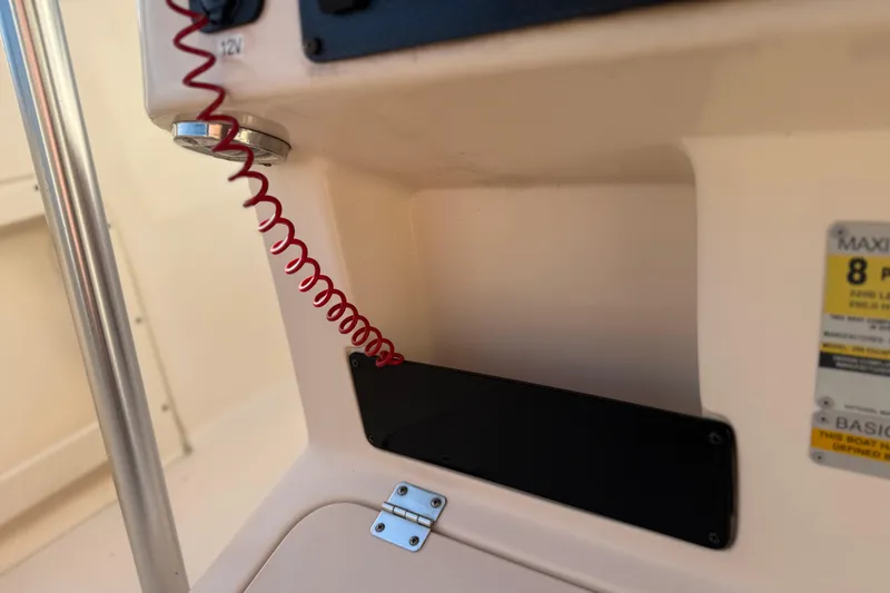 Slide: The Image of 2007 Grady-White Escape 209 boat dashboard with safety lanyard and capacity label. - 26