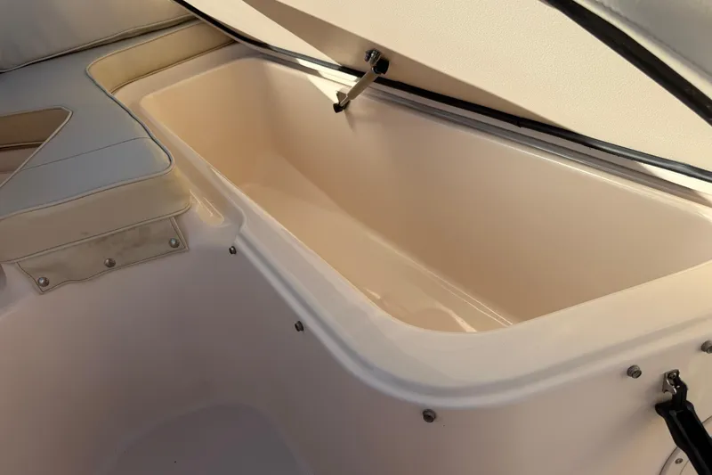 Slide: The Image of 2007 Grady-White Escape 209 boat storage compartment with cushioned seating. - 33