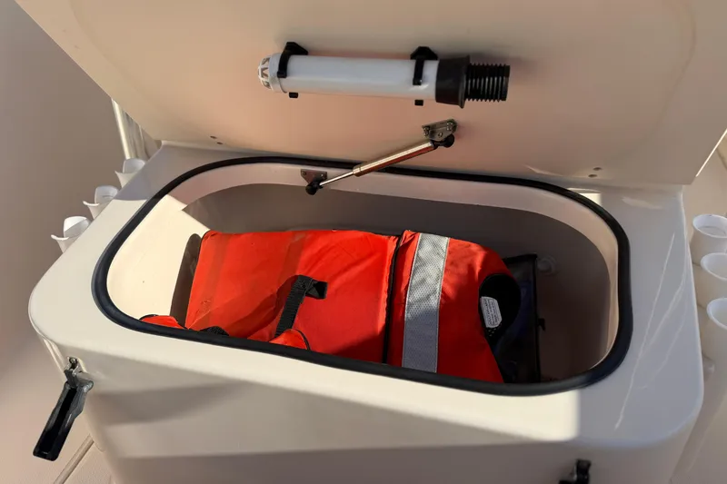 Slide: The Image of Open storage compartment with life jacket on 2007 Grady-White Escape 209 boat. - 36