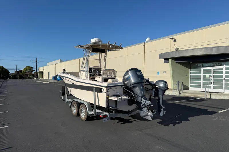Slide: The Image of 2007 Grady-White Escape 209 boat on trailer, parked near industrial building. - 9