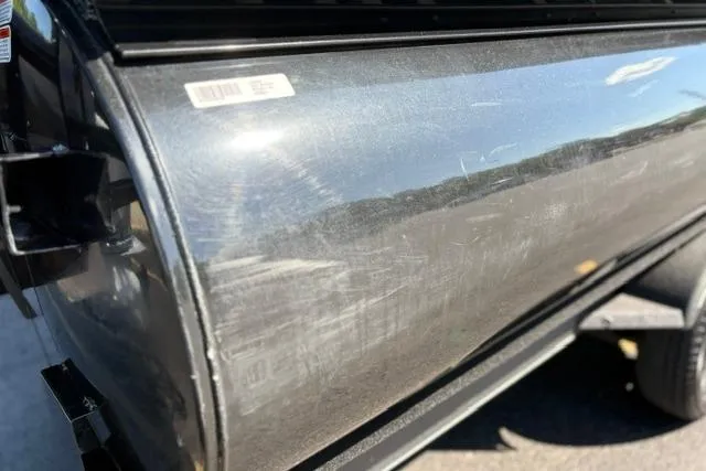 Slide: The Image of 2025 Regency 250 DL3 boat exterior with visible surface scratches and reflections. - 13