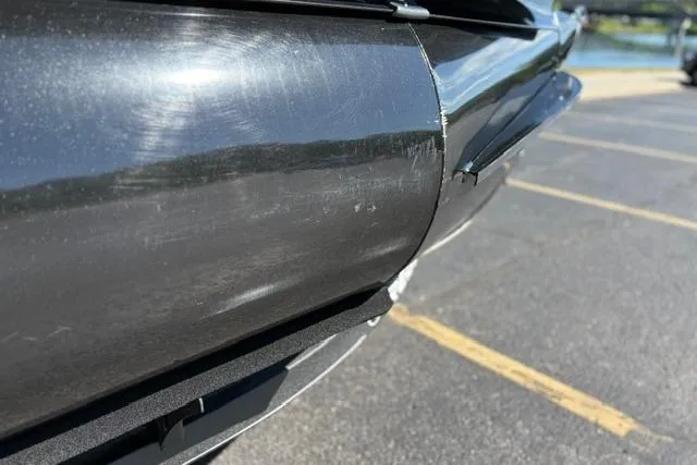 Slide: The Image of Close-up of 2025 Regency 250 DL3 pontoon boat detail in a parking lot. - 15