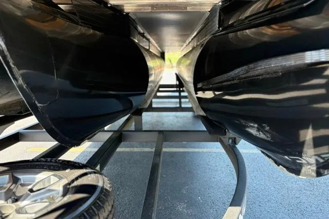 Slide: The Image of Underneath view of a 2025 Regency 250 DL3 pontoon boat on a trailer. - 20