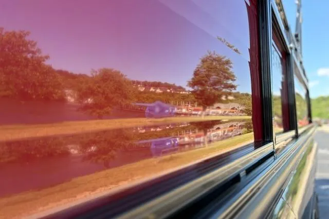 Slide: The Image of Reflection of trees and landscape on a 2025 Regency 250 DL3 vehicle. - 25
