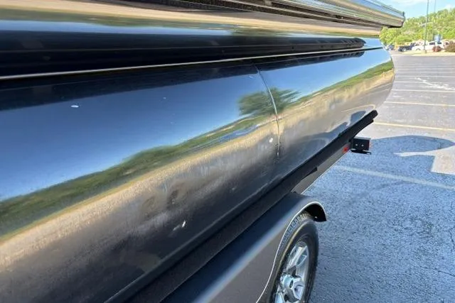 Slide: The Image of 2025 Regency 250 DL3 pontoon boat on trailer, close-up side view in parking lot. - 27
