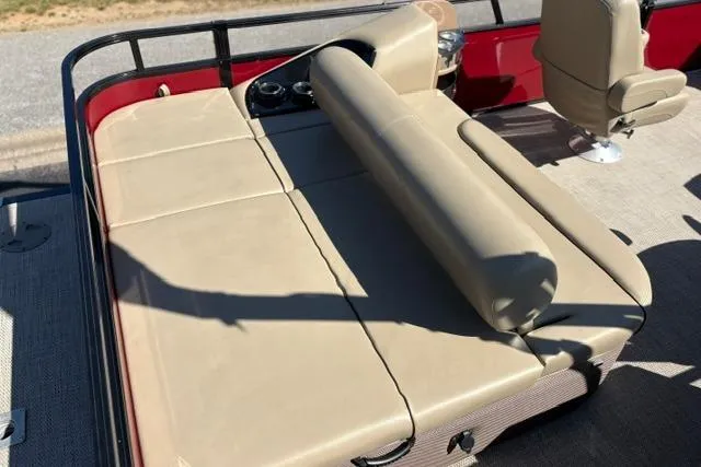 Slide: The Image of 2025 Regency 250 DL3 boat with beige seating and red accents. - 34
