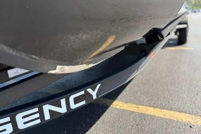 Slide: The Image of 2025 Regency 250 DL3 boat trailer with visible wear on the hull. - 42
