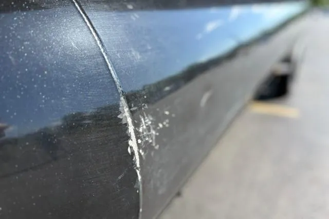 Slide: The Image of Close-up of a scratched 2025 Regency 250 DL3 boat hull. - 44