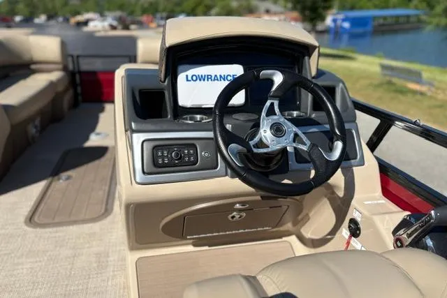 Slide: The Image of 2025 Regency 250 DL3 boat dashboard with steering wheel and Lowrance navigation system. - 46