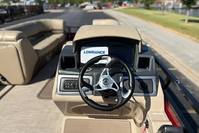 Slide: The Image of ```json "2025 Regency 250 DL3 boat dashboard with steering wheel and Lowrance display." ``` - 47