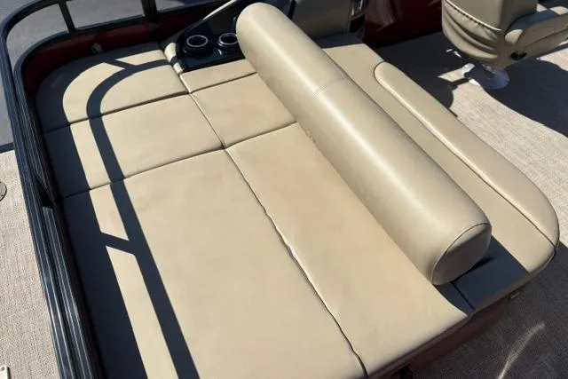 Slide: The Image of Luxurious seating on 2025 Regency 250 DL3 pontoon boat, featuring beige upholstery and cup holders. - 48