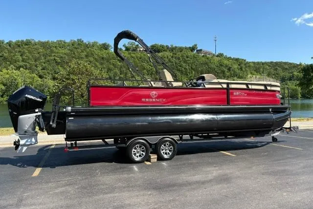 Slide: The Image of 2025 Regency 250 DL3 pontoon boat on trailer, parked in scenic outdoor setting. - 5