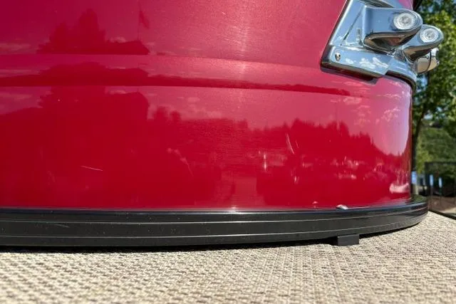 Slide: The Image of Close-up of a red 2025 Regency 250 DL3 boat exterior detail. - 52